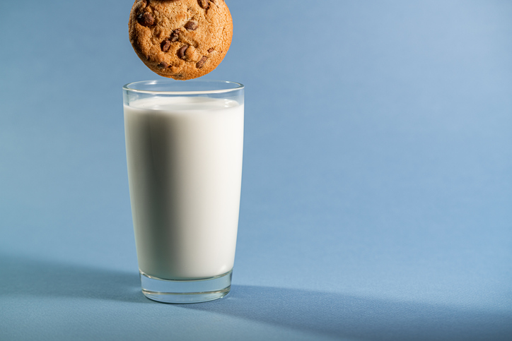 Chocolate cookies biscuit dipped with a glass of milk